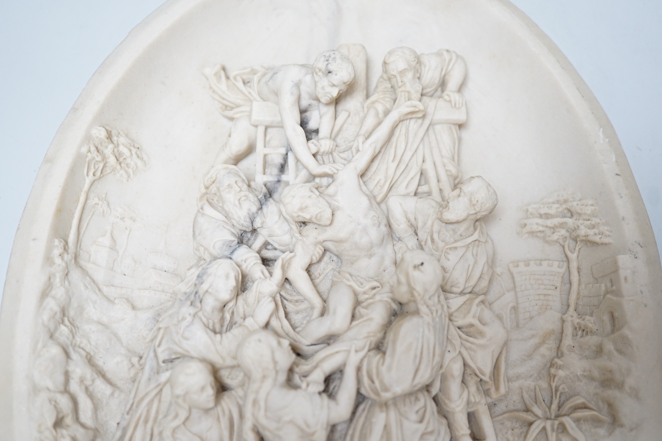A reproduction reconstituted marble oval plaque with inset coin to reverse, 30cm